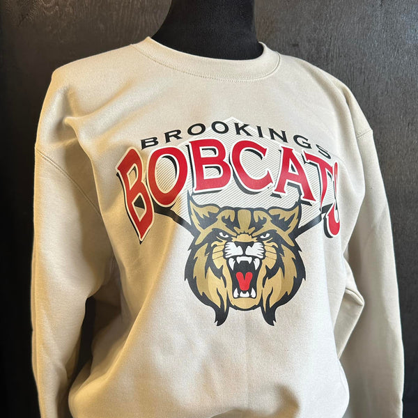 Beige sweatshirt with 'Brooking Bobcats' and bobcat logo made by Cotton and Customs LLC