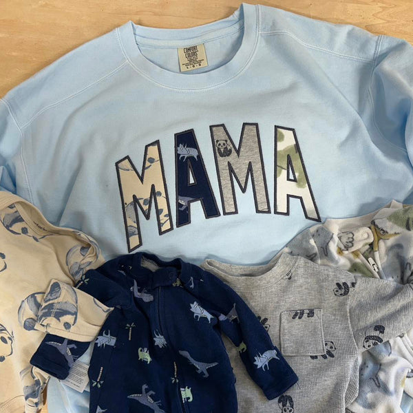 Light blue sweatshirt with 'MAMA' text, made from baby clothes in Volga SD