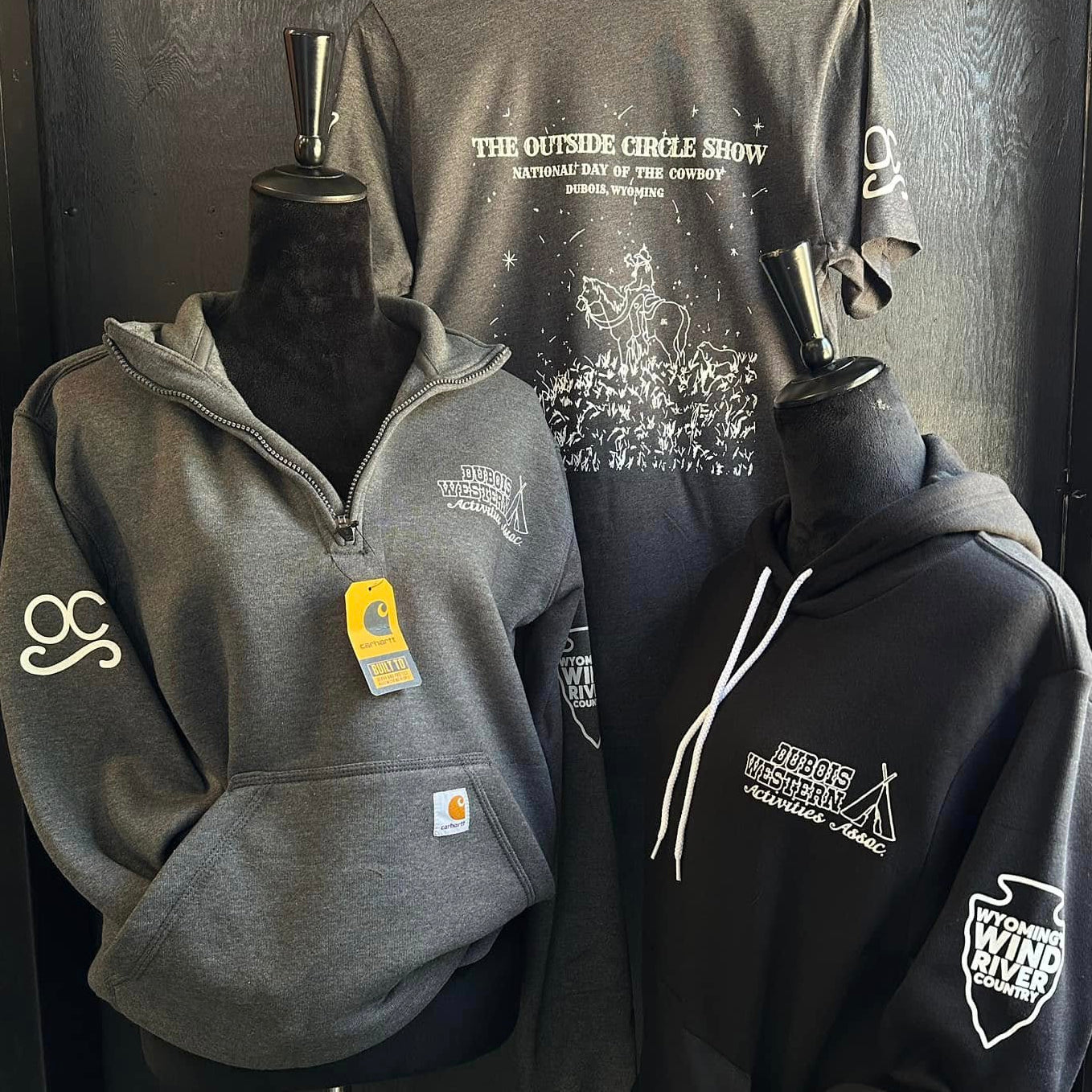 Gray and black hoodies with visible screen printed branding on a mannequin and hanger against a dark background at Cotton & Customs