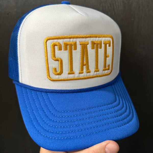 Blue and white cap with 'STATE' embroidery on a black background State Patch Foam Trucker Hat