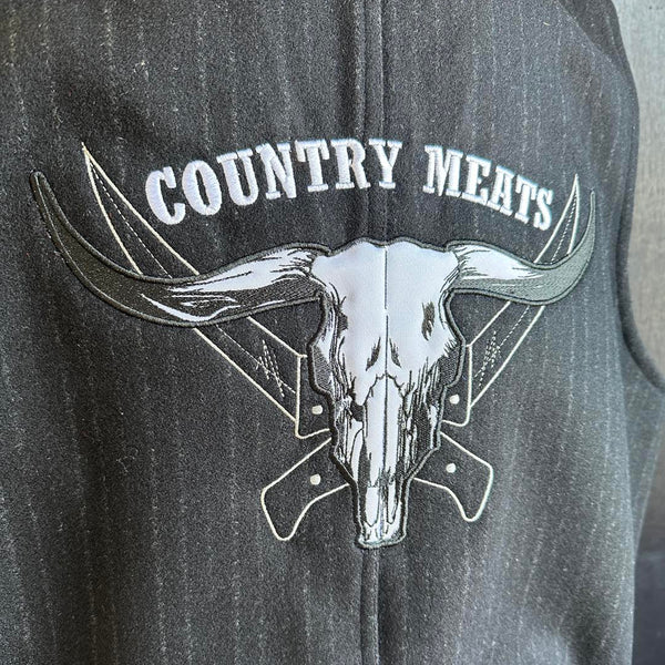 Black vest with embroidered 'Country Meats' logo featuring a longhorn skull design.