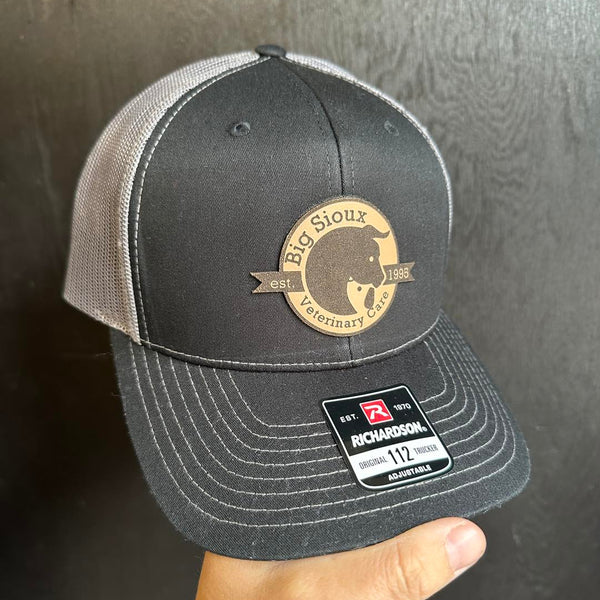 black and charcoal richardson 112 hat with leather patch made at Cotton and Customs LLC.